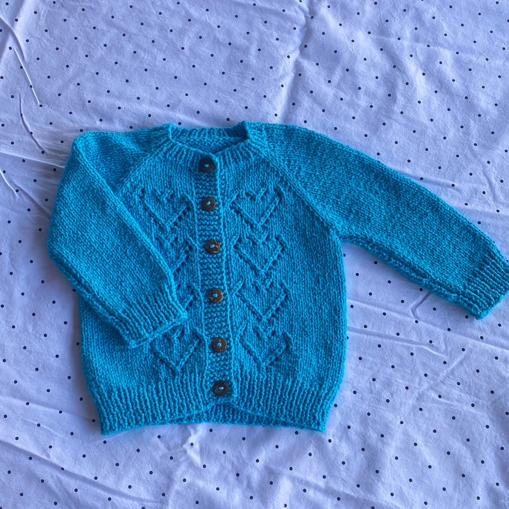 Hand knitted baby girl sweater. New